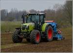 Claas 640 Arion Traktor mit Bodenauflockerer und Shmaschine beim Bodenauflockern und Einshen von Grassaat auf einem Feld.  08.04.2013