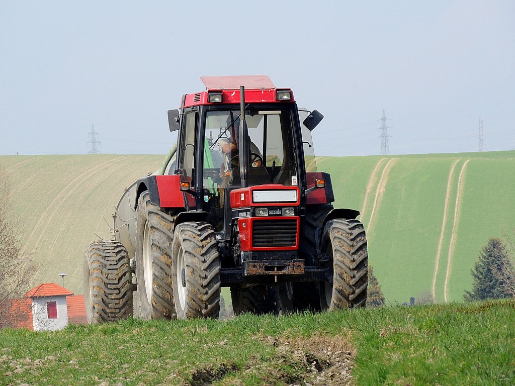 CASE-IHC 1056XL zieht ein leeres Gllefass durch Feld u. Flur; 130415