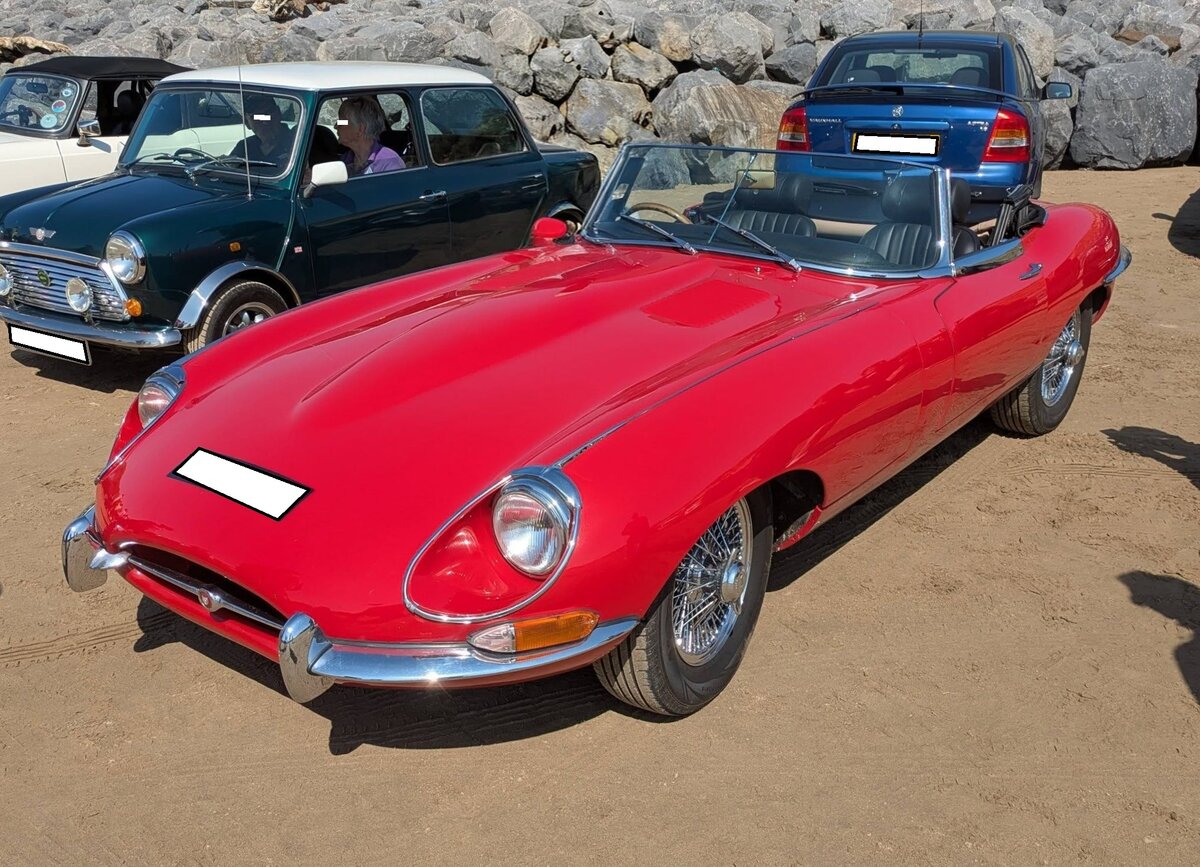 Jaguar E Type Series 2 Roadster im Farbton carmin red. Produziert wurden die Series 2 Modelle von 1964 bis 1971. Der E Type wurde bereits 1961 vorgestellt. Anfangs wurde er noch vom 3.8l Sechszylinderreihenmotor aus dem Vorg�ngermodell XK 150 befeuert. Im Jahr 1964 wurde der Hubraum auf 4.235 cm� aufgebohrt und die Series 2-Modelle waren geboren. Die Motorleistung blieb allerdings gleich. Lediglich das Drehmoment und die Vollgasfestigkeit ver�nderten sich. Ab Herbst 1971 wurde der bew�hrte Sechszylindermotor gegen einen V12-Motor ausgetauscht und das ganze nannte sich dann Jaguar E Type Series 3. Oldtimertreffen anl�sslich des 100´ten Jahrestages der Rekordfahrt von BABS am 27.04.2026 am Strand von Pendine Sands/West Wales.