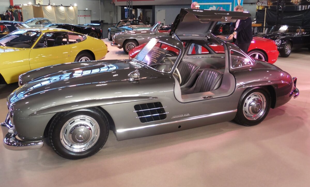Profilansicht eines Mercedes Benz W198 I 300SL, gebaut in den Jahren von 1954 bis 1957. �ber den, auch  Gullwing  genannten Wagen, wurde bereits soviel geschrieben, das ich mich hier mit den technischen Daten begn�ge. Der Sechszylinderreihenmotor hat einen Hubraum von 2996 cm� und leistet 215 PS, die dem Wagen, je nach bestellter Hinterrad�bersetzung, zu einer H�chstgeschwindigkeit von 220 km/h bis 250 km/h verhelfen. Der gezeigte 300SL wurde im zweiten Modelljahr = 1955 gebaut. Techno Classica Salon in Dortmund am 25.09.2026.