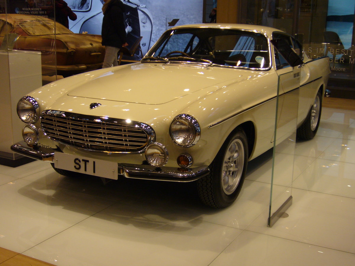 Volvo P1800S aus dem Modelljahr 1967. Der abgelichtete Wagen wurde 02.02.1967 auf den britischen Filmschauspieler Roger Moore, der leider am 23.05.2017 verstorben ist, zugelassen. Der Wagen wurde diente auch als Filmfahrzeug für die Fernsehserie  The Saint , in der Roger Moore die Hauptrolle spielte. Der Vierzylinderreihenmotor hat einen Hubraum von 1778 cm³ und leistet 103 PS. Die Höchstgeschwindigkeit liegt bei 180 km/h. Techno Classica Essen am 22.03.2018.