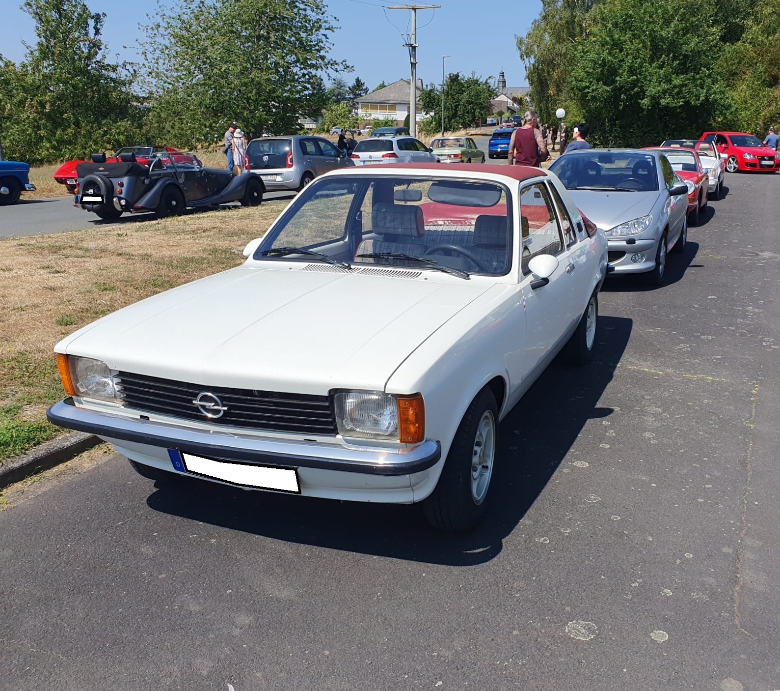 Opel Kadett C Aero im Farbton polarwei�. Produziert wurde der  Aero  in den Jahren von 1976 bis 1978. Die zu einem Freiluftauto umgebaute, zweit�rige Limousine, wurde auf dem Genfer Salon des Jahres 1976 vorgestellt. Dem  Fahrzeug war kein sonderlich gro�er Verkaufserfolg beschieden. Lediglich 1.242 Aero Modelle verlie�en die Werkshallen der Karosseriefabrik Baur/Stuttgart, wo dieses Fahrzeug montiert wurde. Der K�ufer konnte zwischen zwei Vierzylinderreihenmotoren w�hlen: 1196 cm� mit 60 PS oder 1566 cm� mit 75 PS. Oldtimertreffen am Landmuseum Lorch-Ransel am 02.08.2026. 