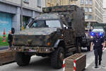 KMW Dino in Tarnfarben, der luxemburgischen Armee, mit einem H�nger auf dem eine Drohne zu sehen ist, war bei der Milit�rparade in Luxemburg zum National Feiertag mit dabei. Der Polizist am rechten Bildrand macht die Zuschauer am Wegesrand darauf aufmerksam das die Drohne breiter als das Fahrzeug ist. 23.06.2025