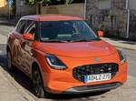 Hier ist ein Suzuki Swift Mk8  AOL  in der Farbe  Flame Orange  zu sehen.