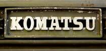 KOMATSU, Schriftzug an der Front einer betagten schweren Planierraupe, die japanische Firma wurde 1921 gegrndet und ist heute der zweitgrte Hersteller von Baumaschinen weltweit, Dez.2015