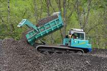 . IHI iC 100 Raupendamper entldt seinen Kipperinhalt auf einem Schotterhaufen.  15.05.2016