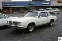 Ein alter Oldsmobil geparkt vor einen Supermarkt in den USA.