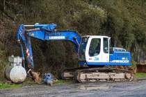 Liebherr Raupenbagger abgestellt am Rande einer Baustelle.  April 2019