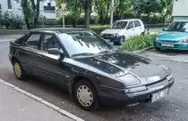 Mazda 323F, aufgenommen in Pécs (HU), Juli, 2019.
