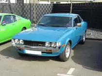 Toyota Celica TA23 ST des Modelljahres 1976. Das sportliche Modell Celica TA22 wurde 1970 auf der Tokyo Motorshow vorgestellt. Ab 1971 gelangten die ersten Fahrzeuge nach Deutschland. 1975 folgte der gezeigte TA23, dessen Vorderbau 7 cm verlängert wurde, um die nun auch großvolumigere Motoren verbauen zu können. Angetrieben wird dieser Celica von einem Vierzylinderreihenmotor, der aus einem Hubraum von 1968 cm³ 110 PS leistet. Besucherparkplatz der Düsseldorfer Classic Remise.