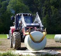 LT-Master, letzter Arbeitsgang, Abtransport der fertig gewickelten Rundballen durch Schlepper mit hydraulischem Frontheber, Sept.2020