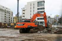 Doosan DX3000S am 24.01.21 in Frankfurt am Main durch den Bauzaun fotografiert von einen Gehweg aus 