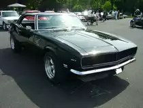 Chevrolet Camaro des Modelljahres 1967 im Farbton tuxedo black. Dieser Camaro ist mit den optional bestellbar gewesenen  Concealed lights  ausgerüstet. Das bedeutet, das nach dem einschalten der Scheinwerfer, sich die vor den Scheinwerfern befindlichen Blenden nach oben schieben. Die Camaro´s bis zum Modelljahr 1969 werden der ersten Generation des Ford-Mustang-Konkurrenten Camaro zugerechnet. Der Camaro war mit etlichen Sechszylinderreihen- und V8-Motoren lieferbar. Der gezeigte Camaro ist mit einem V8-Motor ausgestattet der aus einem Hubraum von 327 cui (5358 cm³) eine Leistung von 210 PS oder 275 PS an die Hinterachse weiter gibt. Oldtimertreffen an Mo´s Bikertreff in Krefeld am 27.06.2021.