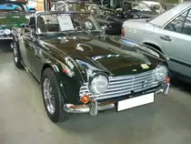 Triumph TR250, gebaut in den Jahren 1968 und 1969. Im Grunde ist der Triumph TR250 ein TR5, der durch Umrüstung auf zwei Vergaser auf die Abgasbestimmungen in den USA, dem wichtigsten Exportland für die Marke Triumph, eingestellt wurde. Der Sechszylinderreihenmotor hat einen Hubraum von 2498 cm³ und leistet 105 PS. Die Höchstgeschwindigkeit gab man bei Triumph mit 172 km/h an. Insgesamt wurden in den zwei Produktionsjahren knapp 8500 Fahrzeuge dieses Typs gebaut. Classic Remise Düsseldorf am 12.07.2022.