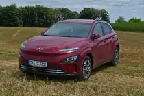 Hyundai Kona Elektrik, stand abseits der Straße auf einem abgemähten Acker.07.2022