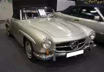 Mercedes Benz W121 BII, gebaut in den Jahren von 1955 bis 1963. Besser bekannt unter der Typenbezeichnung 190SL. Dieser silbergraue 190SL wurde im Jahr 1956 gebaut und wurde nach New York City ausgeliefert. Erst im Jahr 2006 wurde er in sein  Geburtsland  reimportiert. Genau 25.881 Fahrzeuge dieses Typs verließen die Werkshallen von Mercedes Benz. Der Vierzylinderreihenmotor mit einem Hubraum von 1897 cm³ leistet 105 PS. Für einen solchen  Wirtschaftswunder-Sportwagen  waren mindestens DM 16.500,00 fällig. Ab September 1959 konnte der Kunde bzw. die Kundin ein festes Hardtopcoupedach mit bestellen, um im Winter ein festes Dach über dem Kopf zu haben. Dieser  Luxus  kostete noch einmal zusätzlich DM 1.150,00. Essen Motor Show am 06.12.2022.
