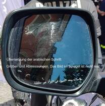 = Aussenspiegel des Toyota Land Cruiser GX.R V8 der Bundespolizei, gesehen beim Tag des Blaulichts 2023 in Hünfeld. Ausgestellt wurde eine gepanzerte Variante des SUV. Unten der im Spiegelglas eingefräste Text, darüber die deutsche Übersetzung. Zum ersten Hünfelder Tag des Blaulichts, am 17.06.2023, präsentierten DRK, THW, LaPo Hessen, Feuerwehr Hünfeld, DLRG, die Justiz und die Bundespolizei einen Teil ihrer Einsatzmittel und warben für ihre Einrichtungen.