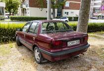 Rückansicht: roter Mitsubishi Lancer Mk4. Foto: Mai, 2022.