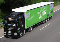 ..der frisch verheiratete Trucker zeigt aller Welt, da� er wohl gl�cklich ist. Auf der A 45 unweit von L�denscheid ist er mit seinem MAN - Megatrailer (Planenauflieger) unterwegs..