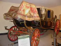 State Landau.

Landaus waren Kutschen die speziell f�r lange Reisen auf schlechten Stra�en gebaut wurden. Sie wurden nicht mehr ben�tigt, als sich die Eisenbahn entwickelte.

State Landaus waren leichtere Bauformen mit k�niglichen Verzierungen und wurden noch bis 1872 gebaut und genutzt f�r Staatsangelegenheiten wie die Er�ffnung des Parlaments.

Traditionell wurde ein State Landau von zwei Pferden gezogen.