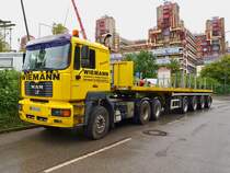 MAN FE 460A mit 4achser Auflieger am 18.08.2010 an der Grobaustelle am Aachener Klinikum. Hier wird ein 15m hoher freitragender Hubschrauberlandeplatz fr zwei Hubschrauber vor dem Klinikum gebaut der ein bisschen an Raumschiff Enterprise erinnert. In Aachen wird er  die Hand Gottes  genannt.