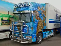 Der  JAHRHUNDERT-TRUCK , eine schön lackierte Scania Zugmaschine mit Frontbügel, einer riesigen Lampenbatterie auf der Stirn aus Edelstahl und einem  einfachen  Kühlauflieger der Spedition Schumacher aus Würselen bei Aachen. Eigendlich gehört an diese Zugmaschine ein passend lackierter Auflieger. Auch dieses Fahrzeug gab es bei Herpa im Maßstab 1:87. Im Hintergrund links steht der Aachen-Truck. Die Fachspedition für Kühltransporte hat einen sehr jungen Fahrzeugpark von ca. 85 Fahrzeugen und ist Europaweit mit ihren zum Teil aufwendig lackierten Lkw`s unterwegs. Aufnahme vom 22.08.2010.