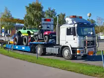 MAN 12.232 Sattelzug mit Fahrzeuge einer Auto Stuntshow beladen am 21.10.2010 vor der Aachener Eissporthalle. Im Hintergrund sieht man den neuen Tivoli, die Anzeigetafel  Noch 260 Tage  bezieht sich auf das Reittunier Chio und nicht auf die Stunt-Show, die kann man am Sonntag den 24.10 bewundern.