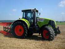 Claas Axion 830, Allradschlepper, 6-Zyl.Turbo-Diesel, 6788ccm, 209PS, mit angebautem 4-Schar-Wendepflug, Traktorentreffen Hausen/Mhlin, Sept.2010