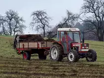 FIAT 45-66DT bringt mit dem mitgefhrten Dngerstreuer Stallmist auf die herbstliche Wiese;101026