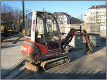 Ein Neuson-Minibagger Typ 1402 RD auf einer Dsseldorfer Baustelle nahe der Straenbahnhaltestelle beim S-Bahn-Haltepunkt Bilk. Als Vorarbeit zu dem Bau der U-Bahn-Strecke  Wehrhahnlinie  wurde hier ein Teil der Elisabethstrae verlegt, um Platz zu schaffen fr den Einstiegsschacht der Tunnelbohrmaschine und die sdliche Tunnelrampe. Diese Aufnahme stammt vom 16.12.2007.