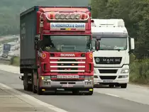 Scania 164L mit Sattelauflieger wird von einem MAN Sattelzug �berholt. Gesehen am 26.07.2011 auf der A4 kurz vor der Niederl�ndischen Grenze.