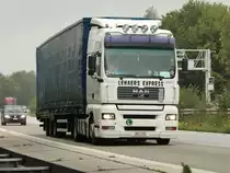 MAN TGA 18.430 D20 Commonrail mit Planenauflieger am 12.08.2011 auf der A4 kurz hinter der Niederlndischen Grenze.