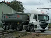 DAF CF85-410 eines Kieswerkes quert einen Bahn�bergang  an der Ostbahn;110919