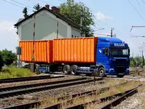 DAF XF105, quert mit Abrollcontainern einen stark befahrenen  Bahnübergang entlang der Ostbahn; 140701